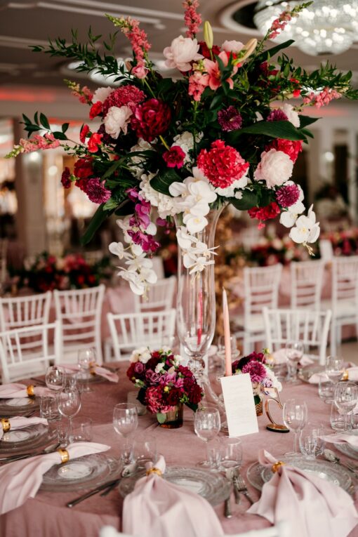 Różowo białe kompozycje kwiatowe na różowym weselu.
